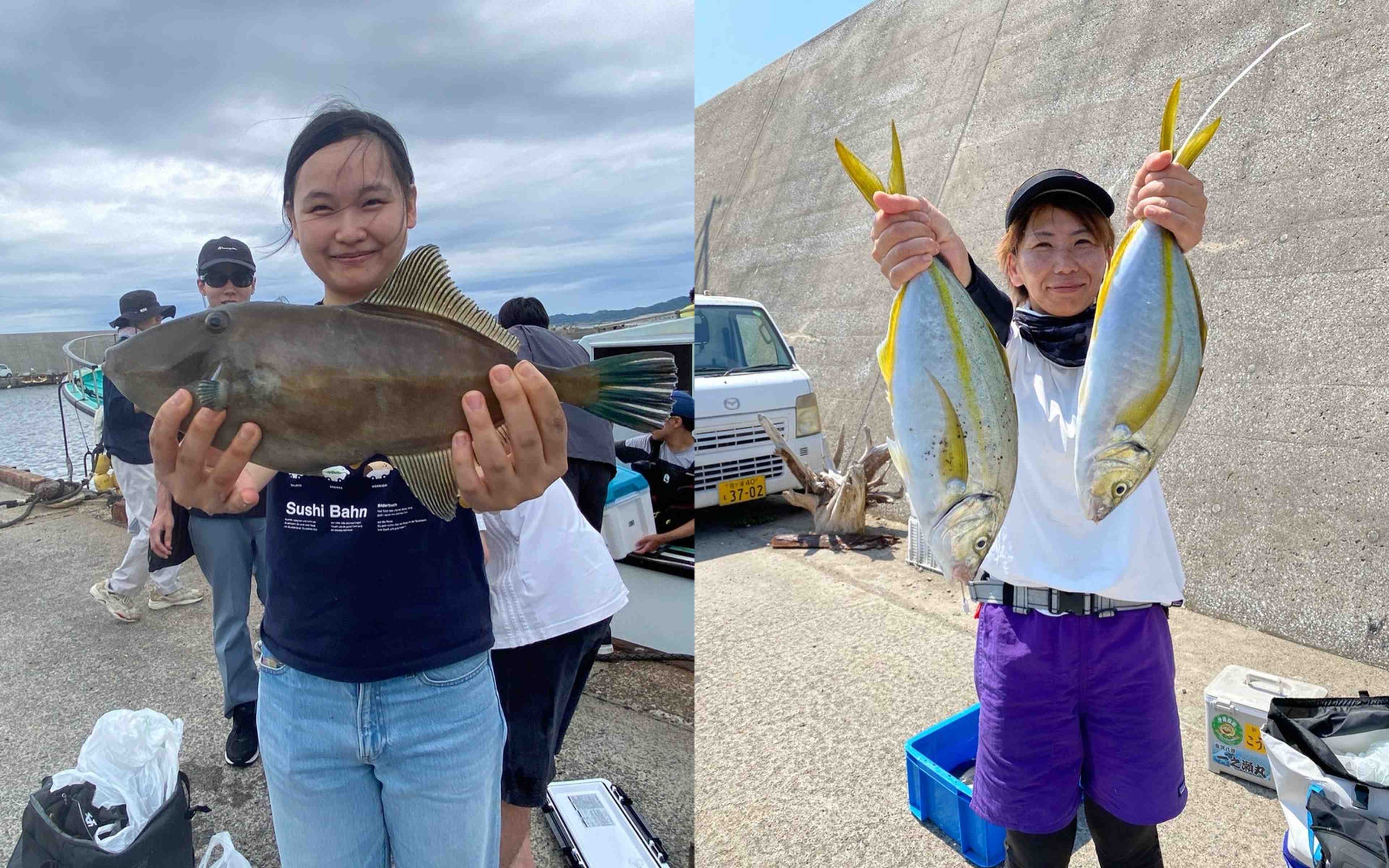 A woman holding a filefish-like catch on a pier, next to another woman lifting two fish in front of a breakwater