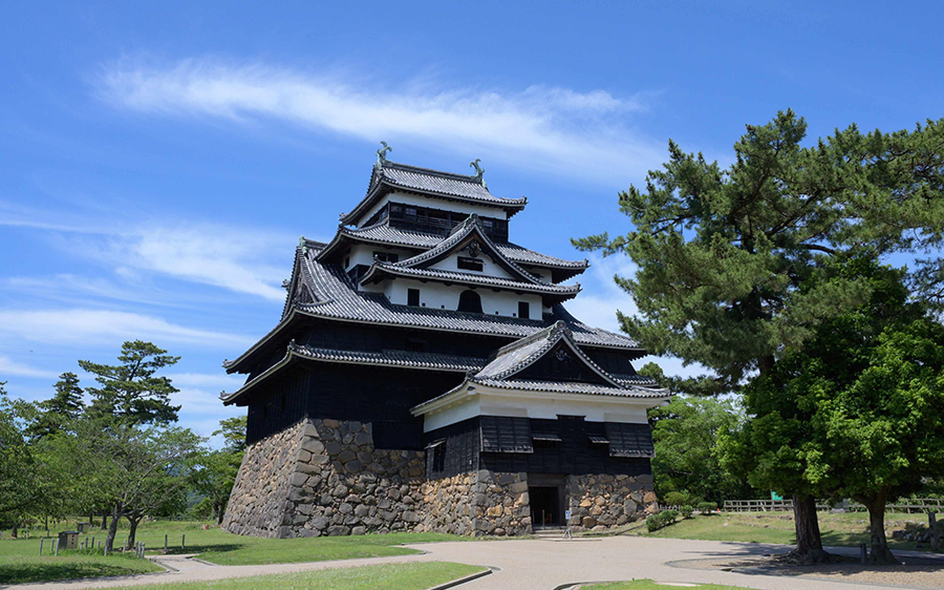The black keep of Matsue Castle under a clear blue sky