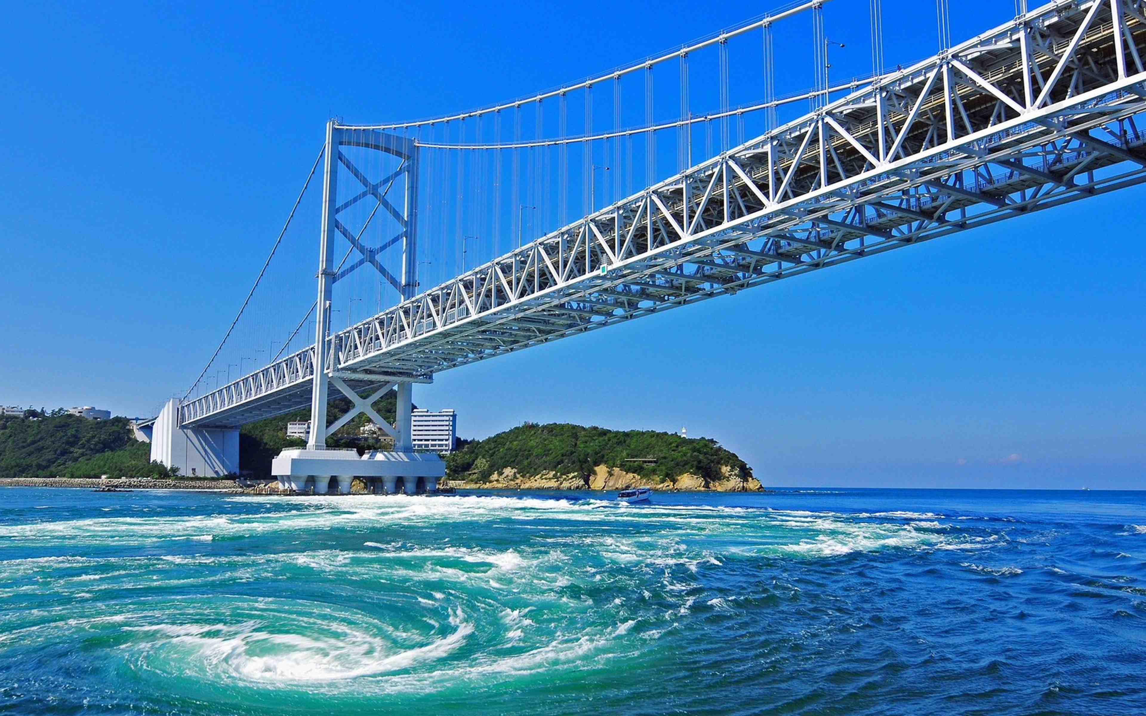 A whirlpool turning in the Naruto Strait beneath the Onaruto Bridge