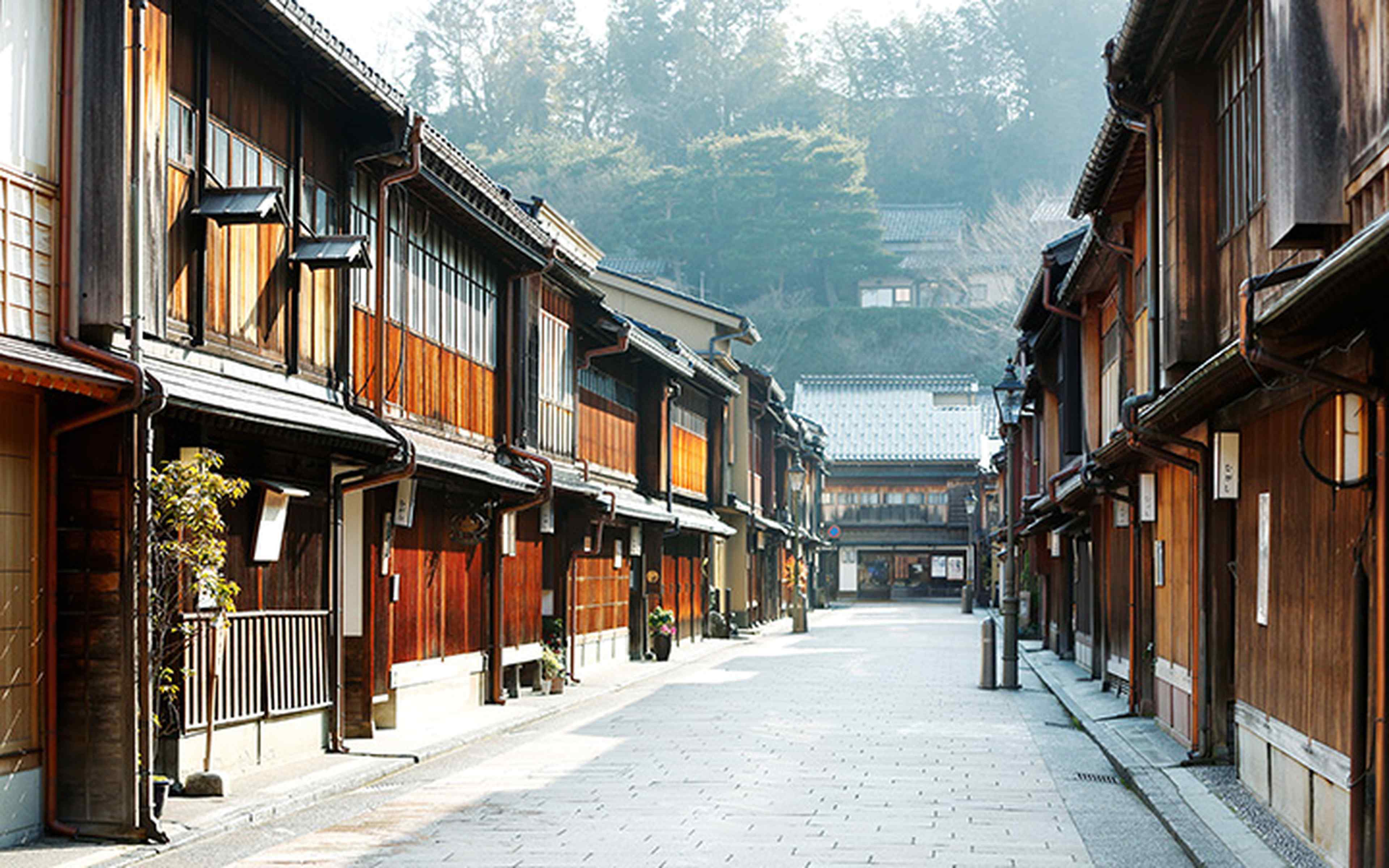 A stone-paved street lined with lattice-fronted teahouses in Kanazawa's chaya district