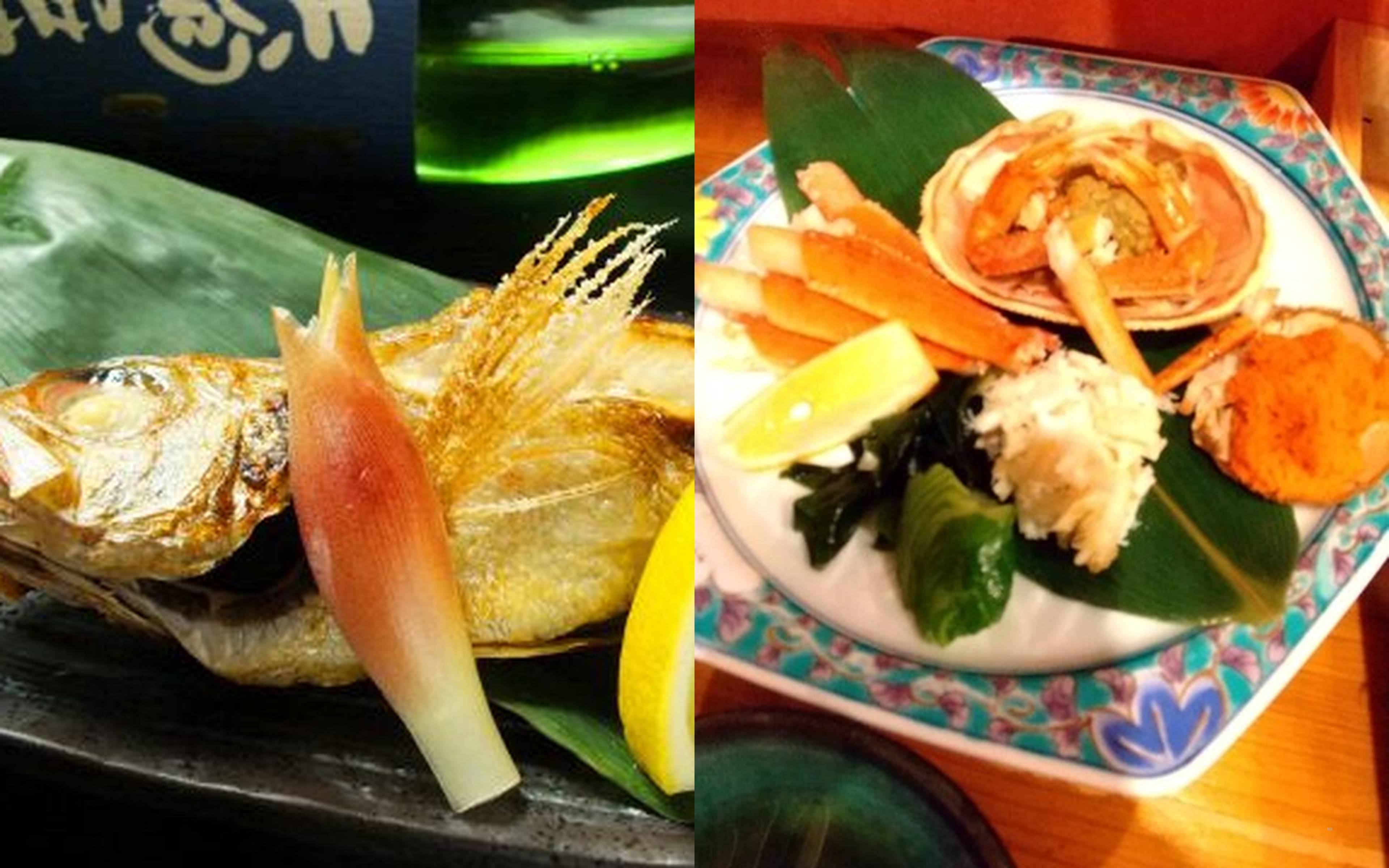 A grilled fish with its tail fanned out, served alongside a plate of snow crab